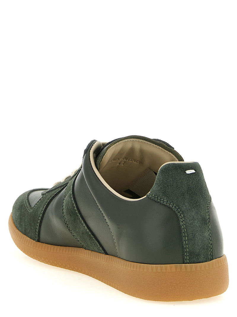 Rear three-quarter view of Maison Margiela Replica Bicolor Calfskin Low Top Sneakers in forest green leather and suede, featuring the signature white heel stitch and honey rubber outsole. Maison Margiela Replica Sneakers available at Urbalenti NYC, style 13879, product code 79680700467, Bicolor, Discount_30-39, EU 40 | US 7, EU 41 | US 8, EU43/US10, in-stock, Low Tops - Sneakers - Shoes, Maison Margiela, Men, New with tags, Shoes, Sneakers - Shoes.
