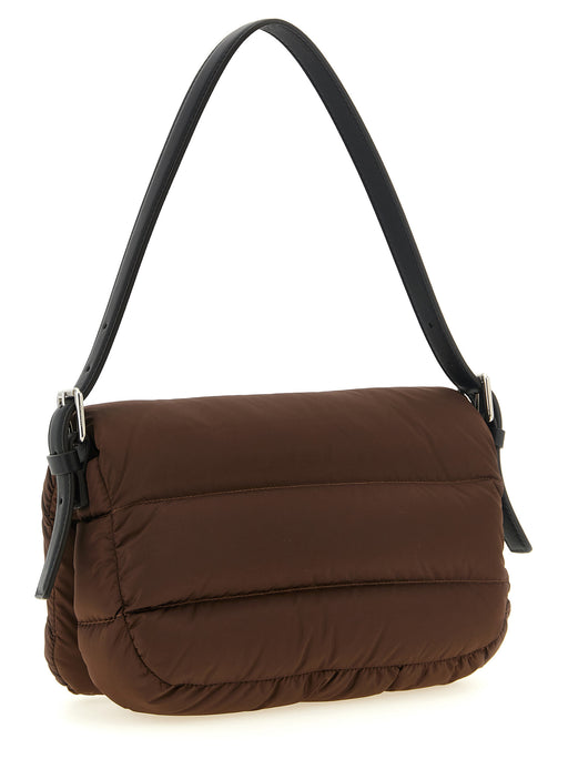 Angled view of the Moncler Caradoc Shoulder Bag in Brown Quilted Nylon with Leather Strap, showcasing its padded boudin quilting and adjustable leather strap. This Moncler bag is available at Urbalenti NYC, style 13879, product 79680700467, in Bags, Brown, Discount_40-49, in-stock, New with tags, Shoulder Bags - Bags, Women.