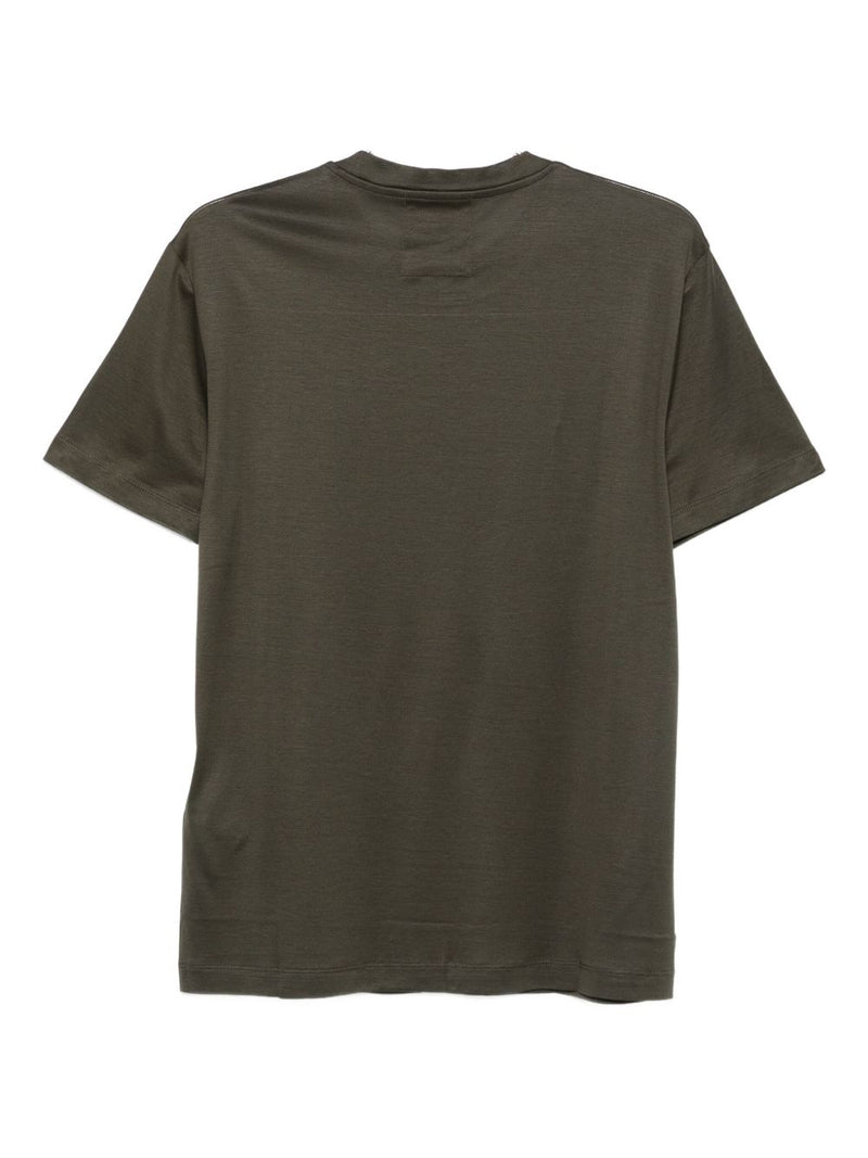 Back view of an Emporio Armani T-Shirt in green, highlighting the minimalist design and quality fabric. Ideal for layering or wearing solo, this best seller from the Fall - Winter 2025 collection offers comfort and sophistication. Discover more from Emporio Armani T-Shirts, designed for men who value style and elegance in their clothing essentials.