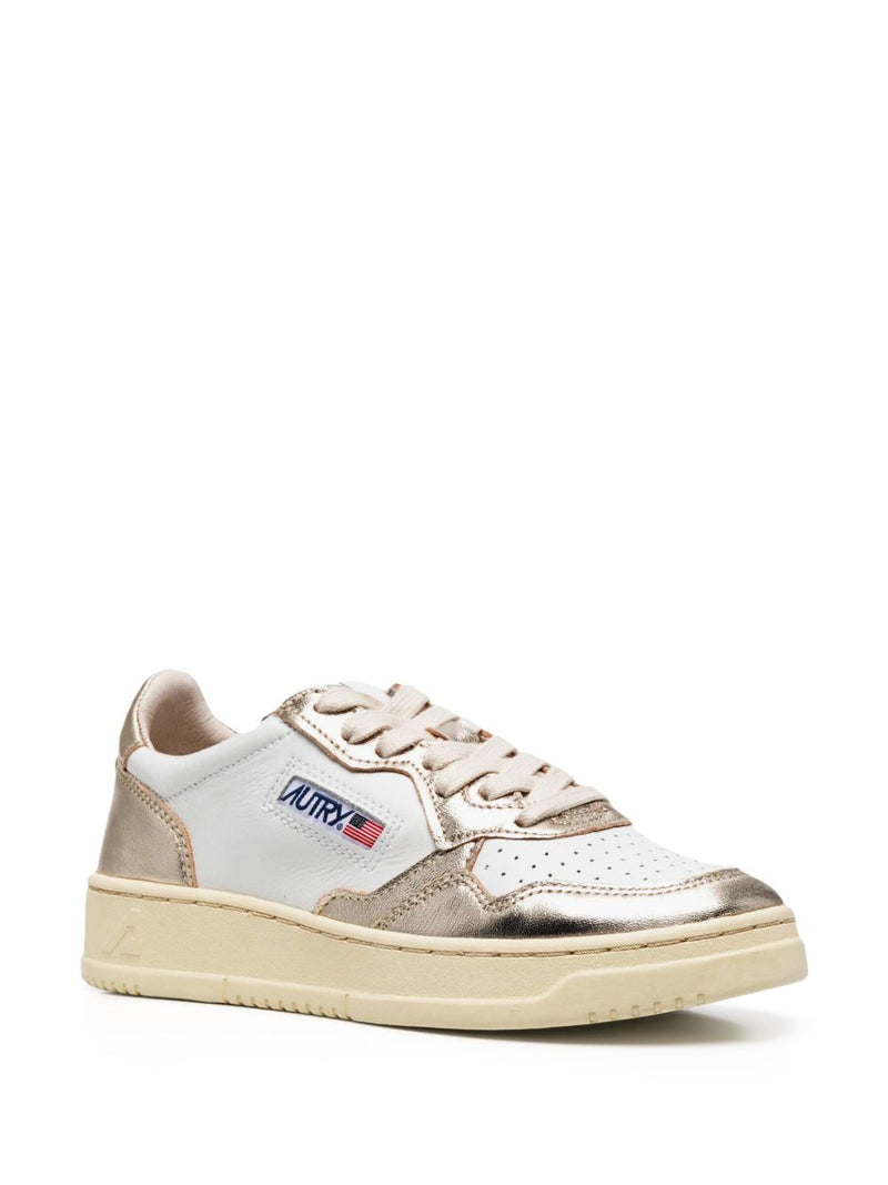 Autry MEDALIST LOW BICOLOR SNEAKERS IN WHITE AND PLATINUM METALLIC LEATHER | Urbalenti™ NYC