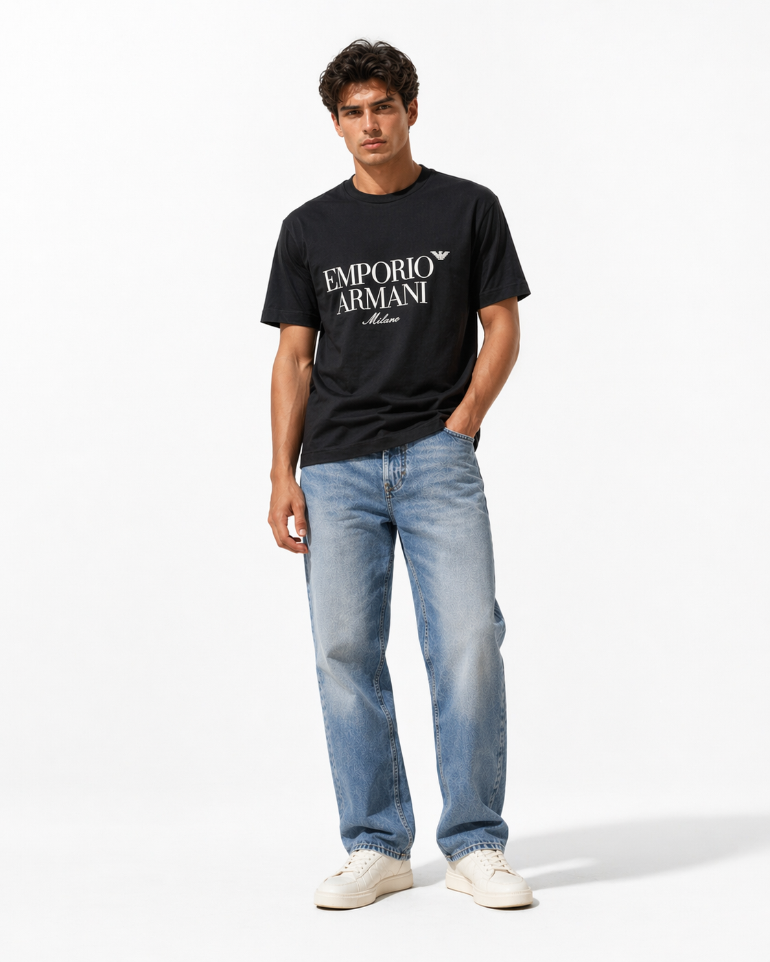 Man wearing a black Emporio Armani t-shirt and blue jeans on a white background
