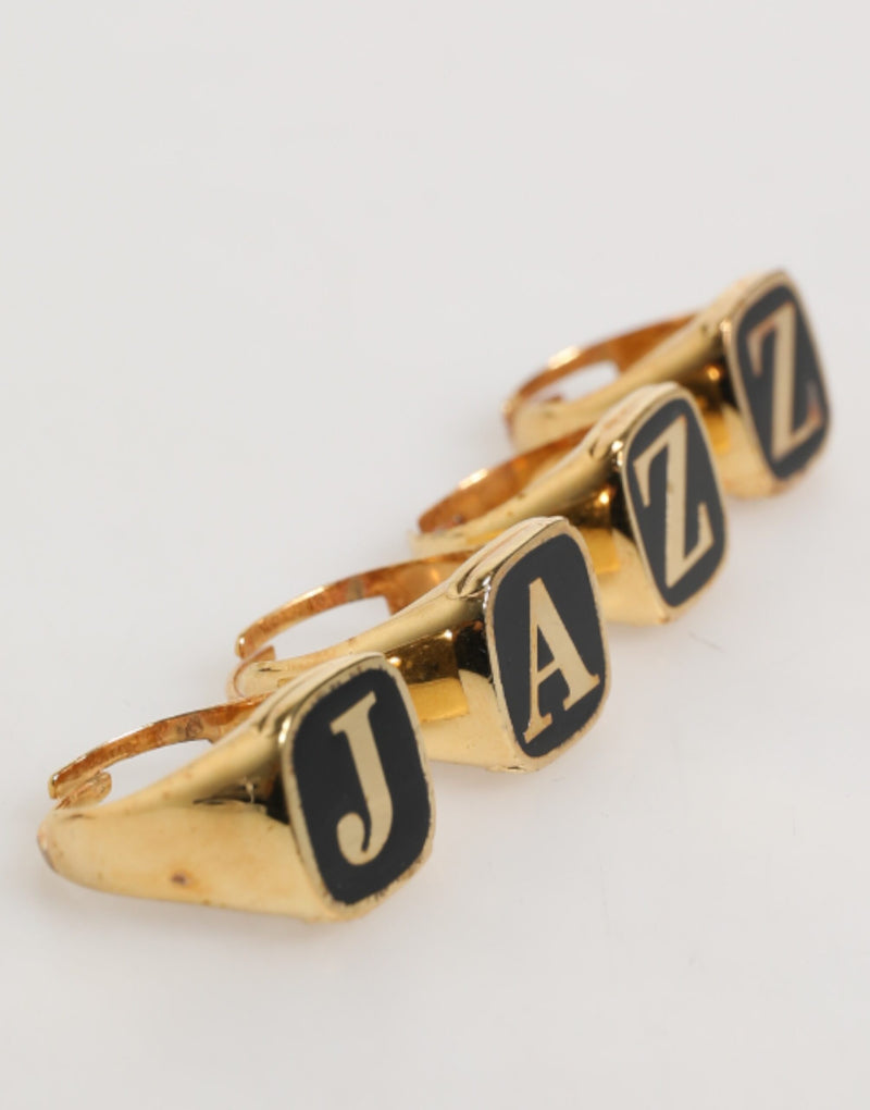 Anillo ajustable con letras JAZZ de latón en tono dorado, juego de 4 piezas Dolce & Gabbana