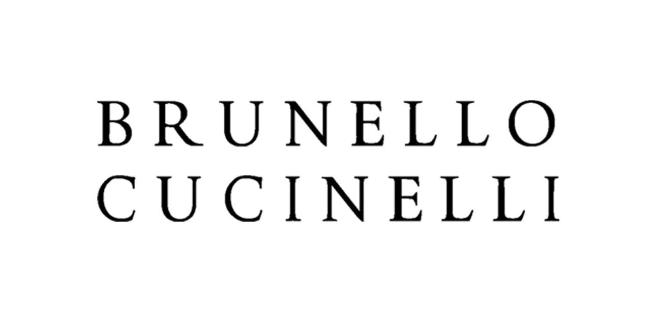Brunello Cucinelli — An elegant depiction of artisanal craftsmanship in a serene workspace featuring the founder of Brunello Cucinelli, surrounded by premium textiles and designs, showcasing the essence of Italian luxury.